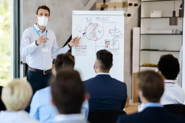 businessman-wearing-face-mask-while-giving-presentation-board-room_637285-9167 (1) businessman-wearing-face-mask-while-giving-presentation-board-room_637285-9167 (1)